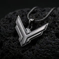 Load image into Gallery viewer, Black rhodium plated House Atreides necklace displayed on textured volcanic stone, showcasing the stylized hawk symbol, layered edges, and distinctive science fiction aesthetic.