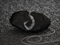 Load image into Gallery viewer, Hand holding a scorpion tail totem pendant, sleek and powerful.