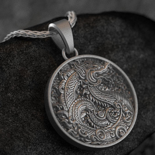 Close-up of round gold dragon medallion necklace with embossed fantasy motif,