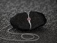 Load image into Gallery viewer, Silver dagger pendant with red gemstone centerpiece.