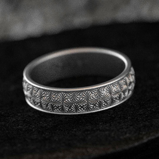 Oxidized silver starburst wedding band with engraved detail