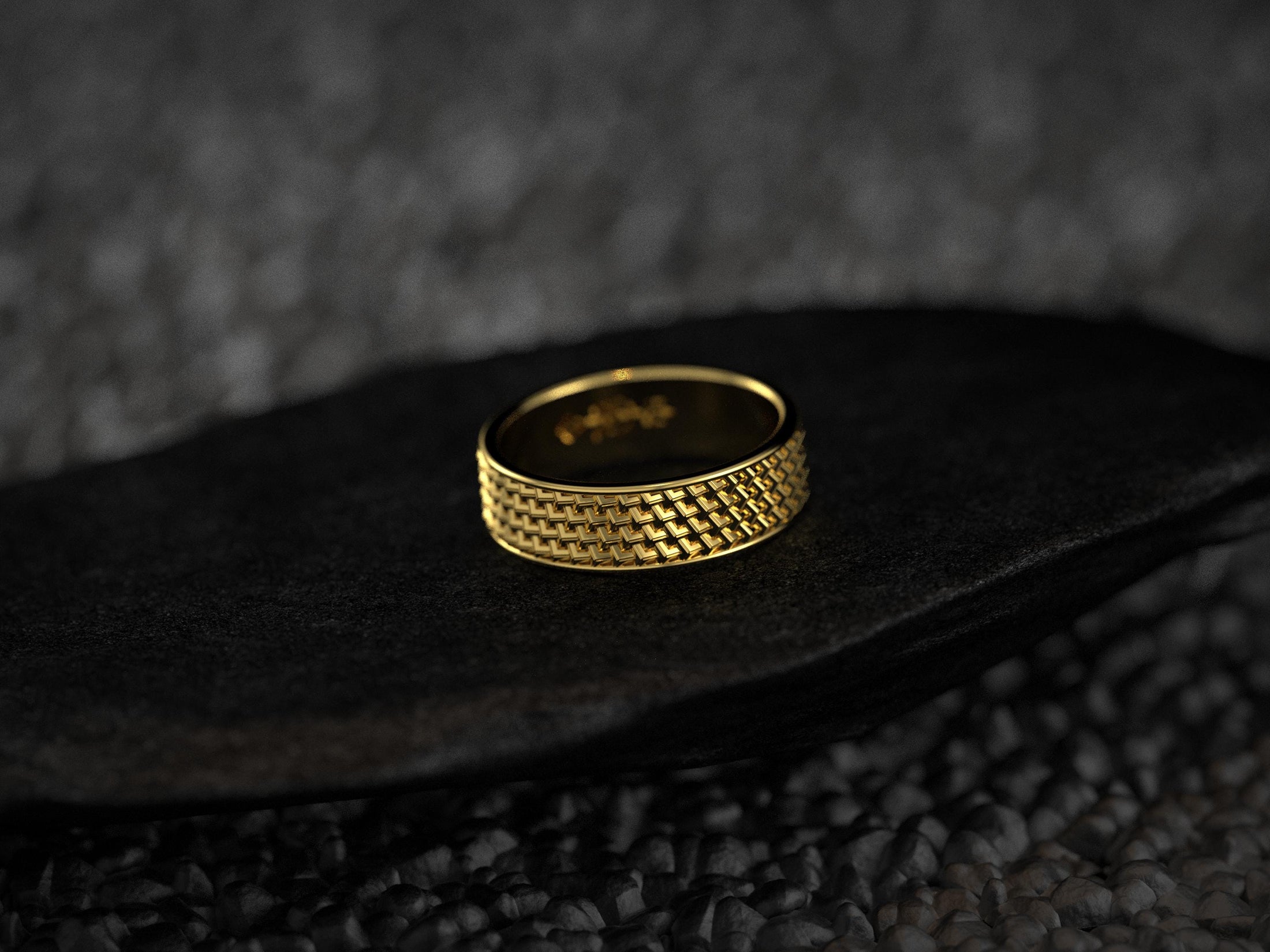 Modern yellow gold ring with woven design on black stone