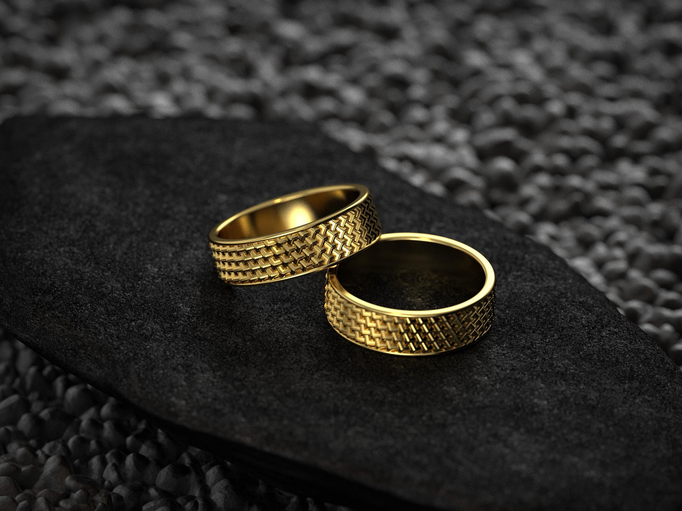 Matching gold wedding bands in woven grid pattern