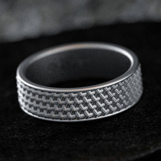 Matte oxidized silver wedding band with woven texture pattern