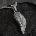 Load image into Gallery viewer, Oxidized silver pegasus wing horse necklace on dark stone background,