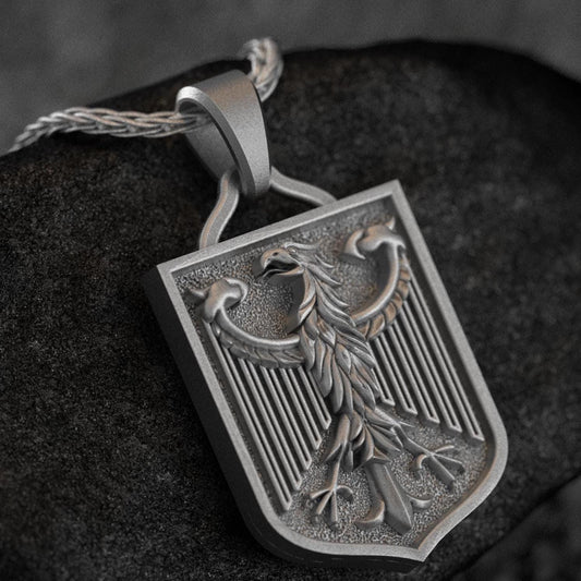 Oxidized silver German Federal Eagle pendant on dark background,
