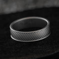 Load image into Gallery viewer, Front view of diagonal groove wedding band on stone background