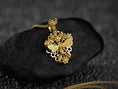 Load image into Gallery viewer, Gold plated bee pendant surrounded by blooms,