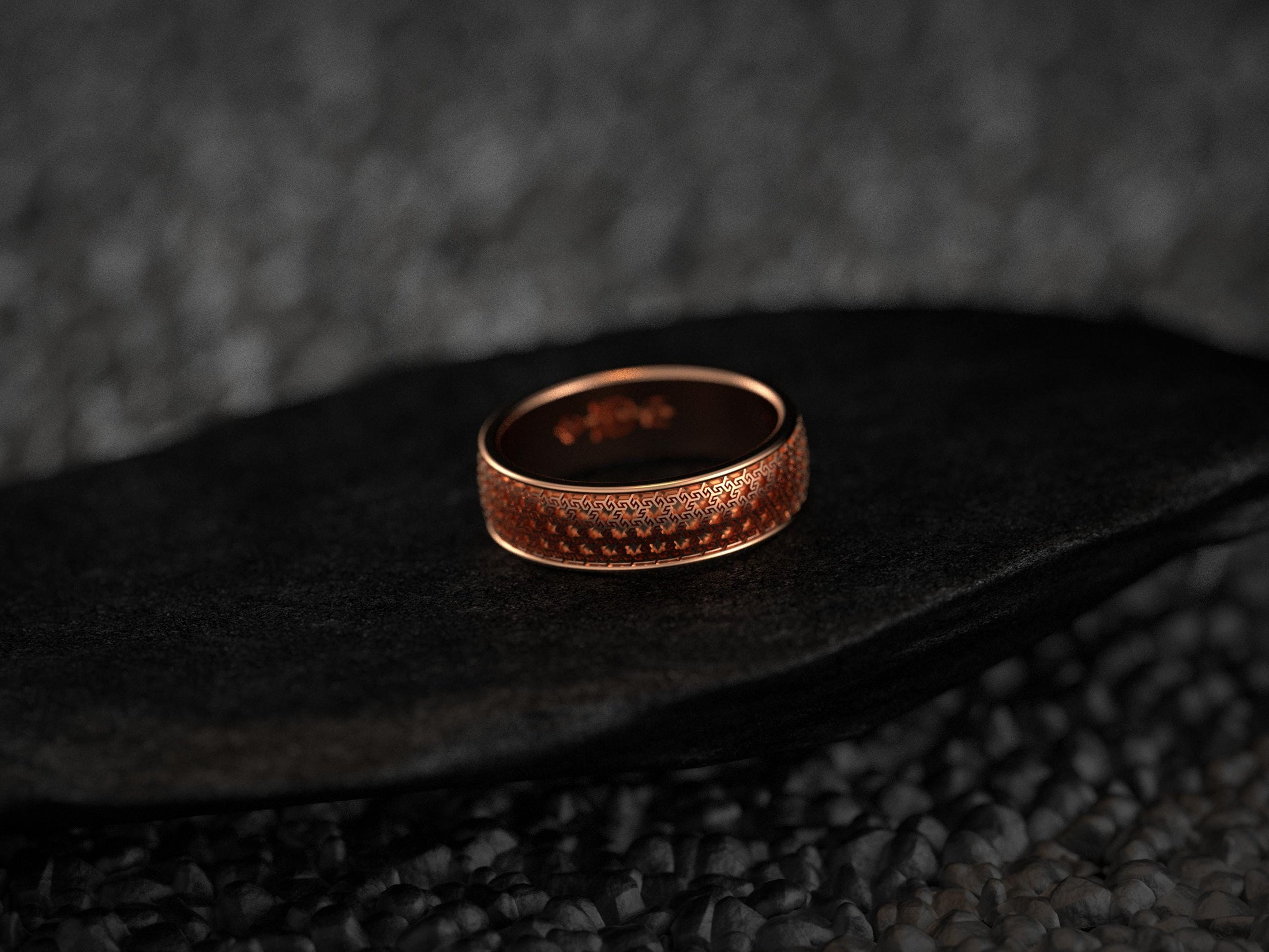 Rose gold wedding ring with intricate Hellenic design