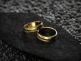 Load image into Gallery viewer, Pair of gold-plated rings showcasing grainy feather pattern
