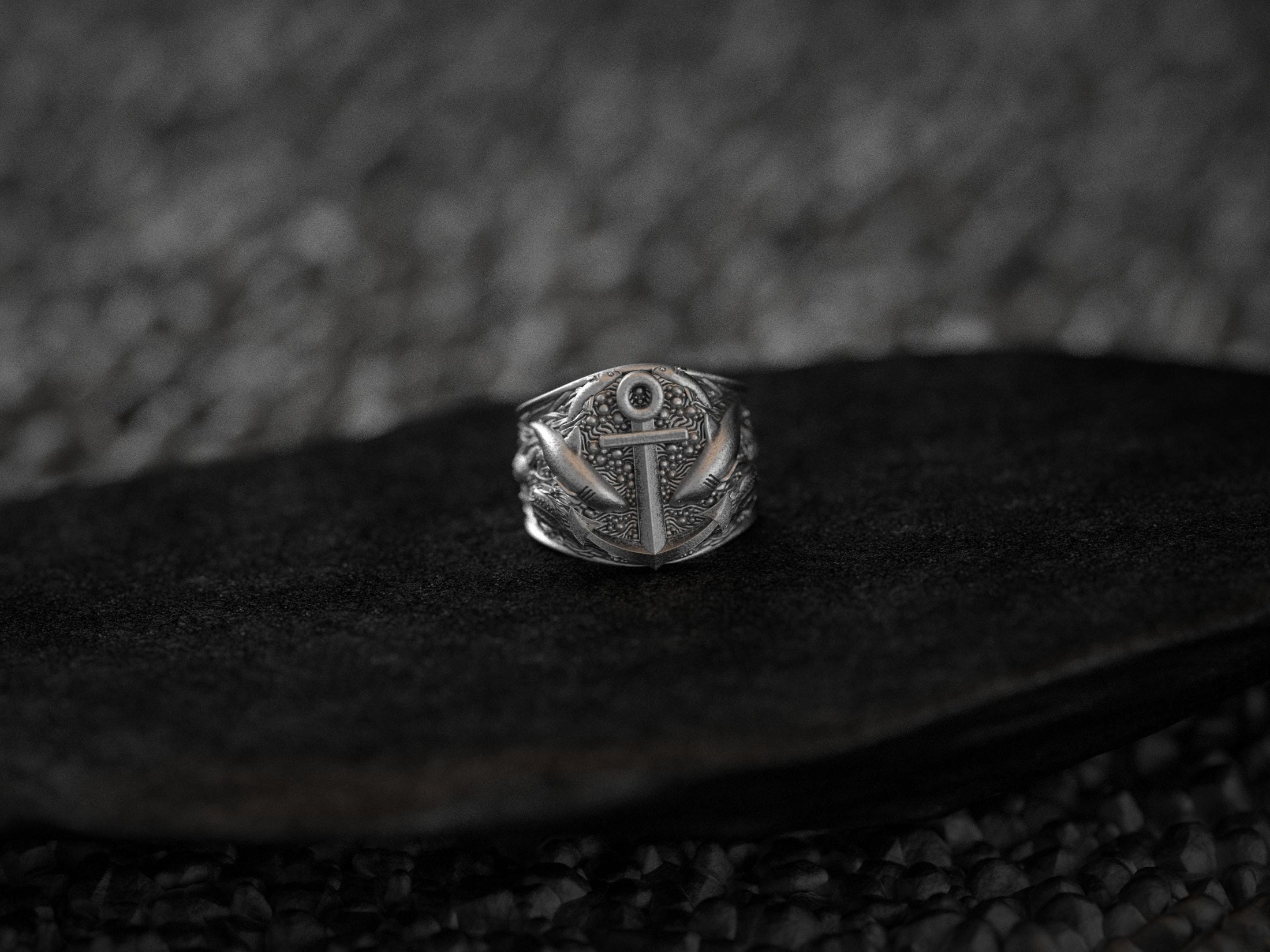 Angled view highlighting shark detailing on silver nautical ring.