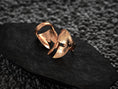 Load image into Gallery viewer, Angled shot of the rose-gold plated ring illustrating its hammered-metal highlights.