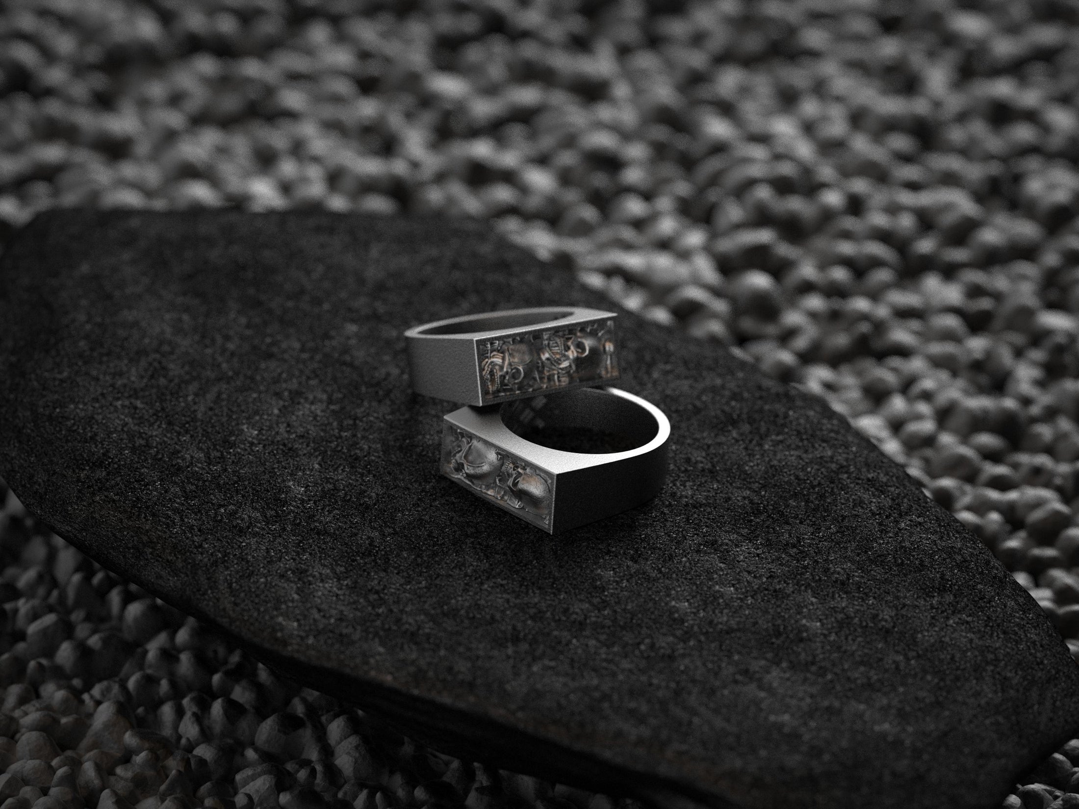Angled shot of the silver ring, displaying the polished band tapering into the detailed bar top.