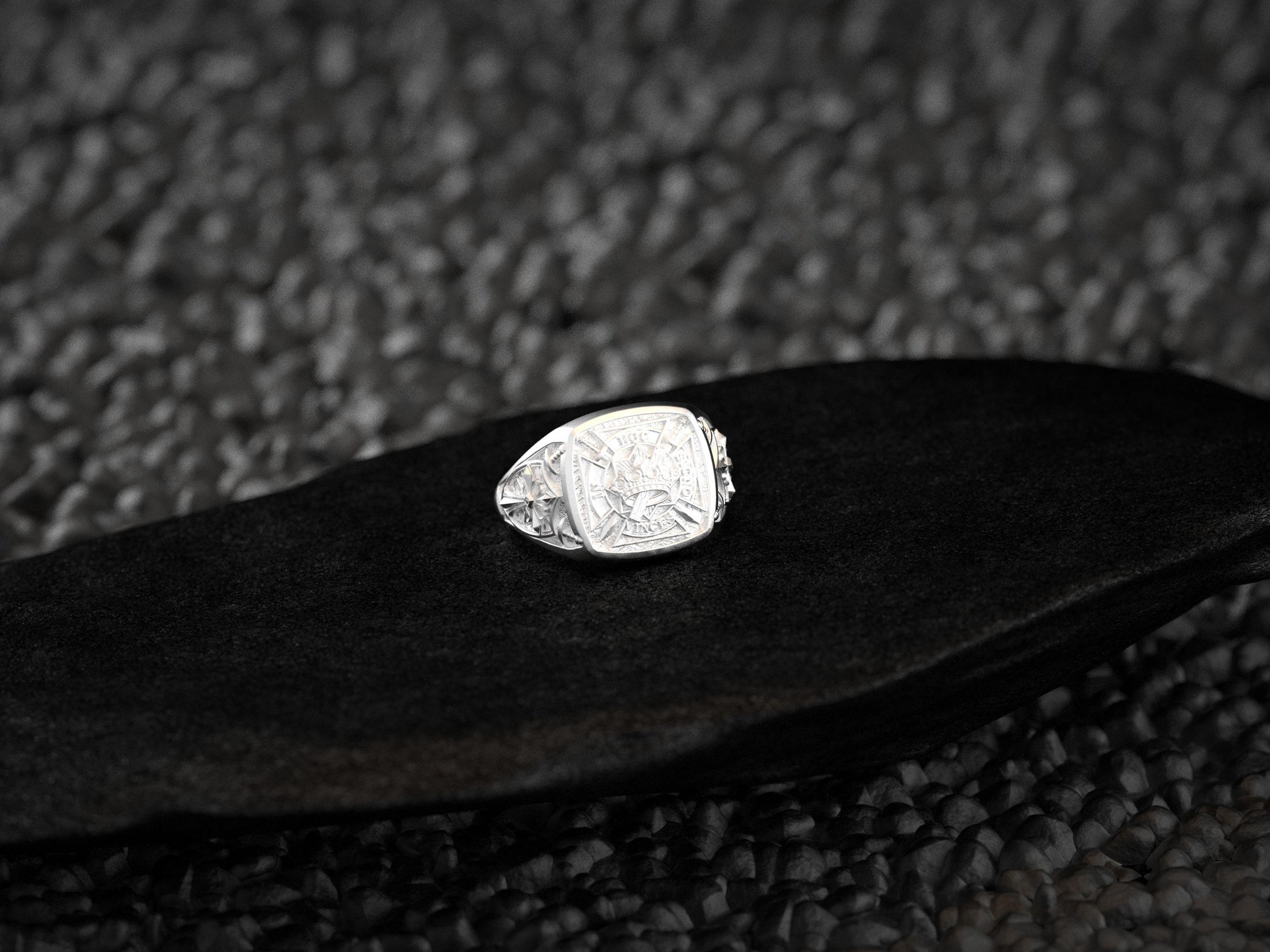 Close-up of crown, cross, and swords with sacred Latin inscription