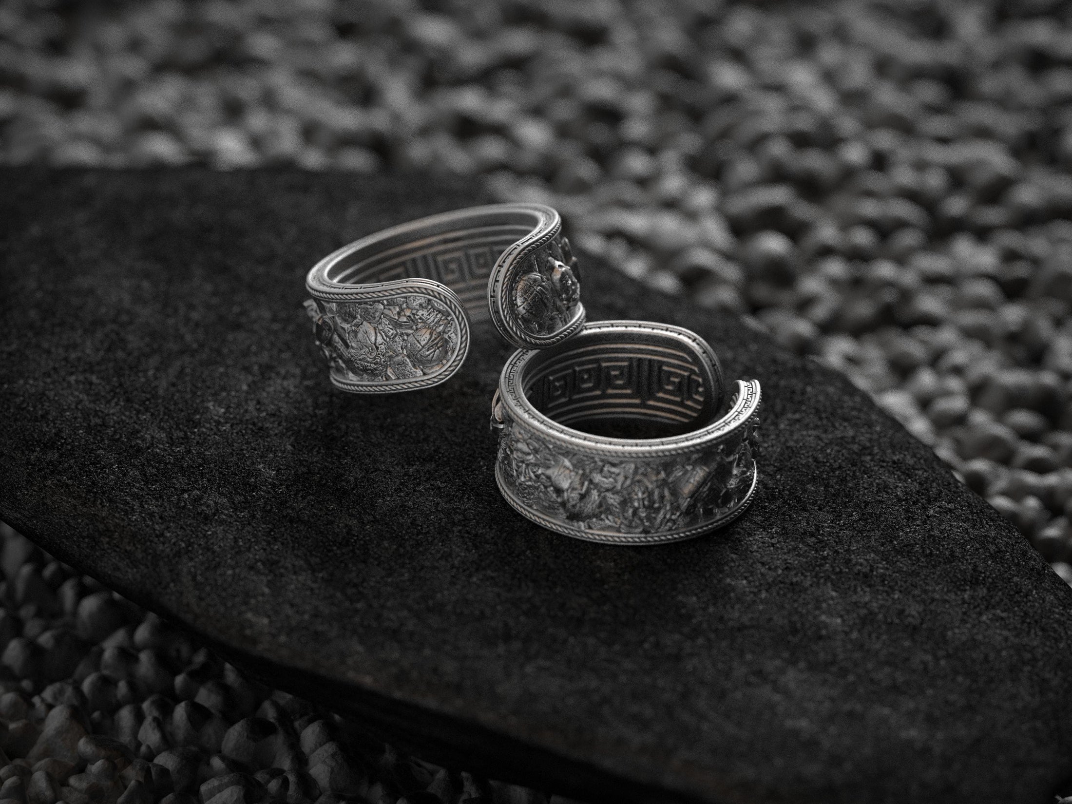 Pair of oxidized ancient Greek cuff rings on black stone
