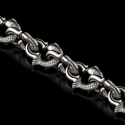 Close-up of fish-shaped silver chain links