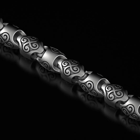 Close-up of silver triskele chain links