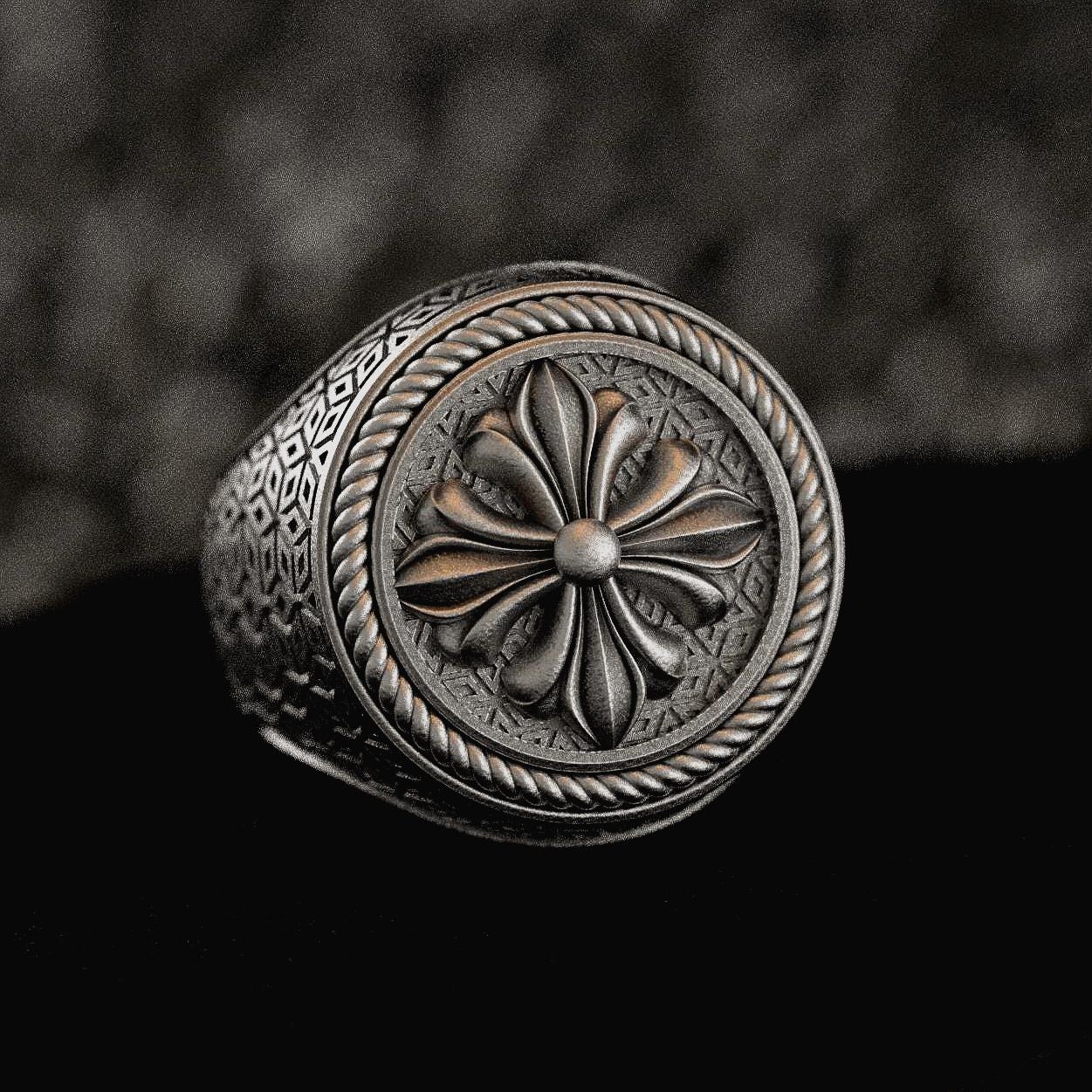 Sterling silver signet ring with fleur-de-lis shield on dark stone,