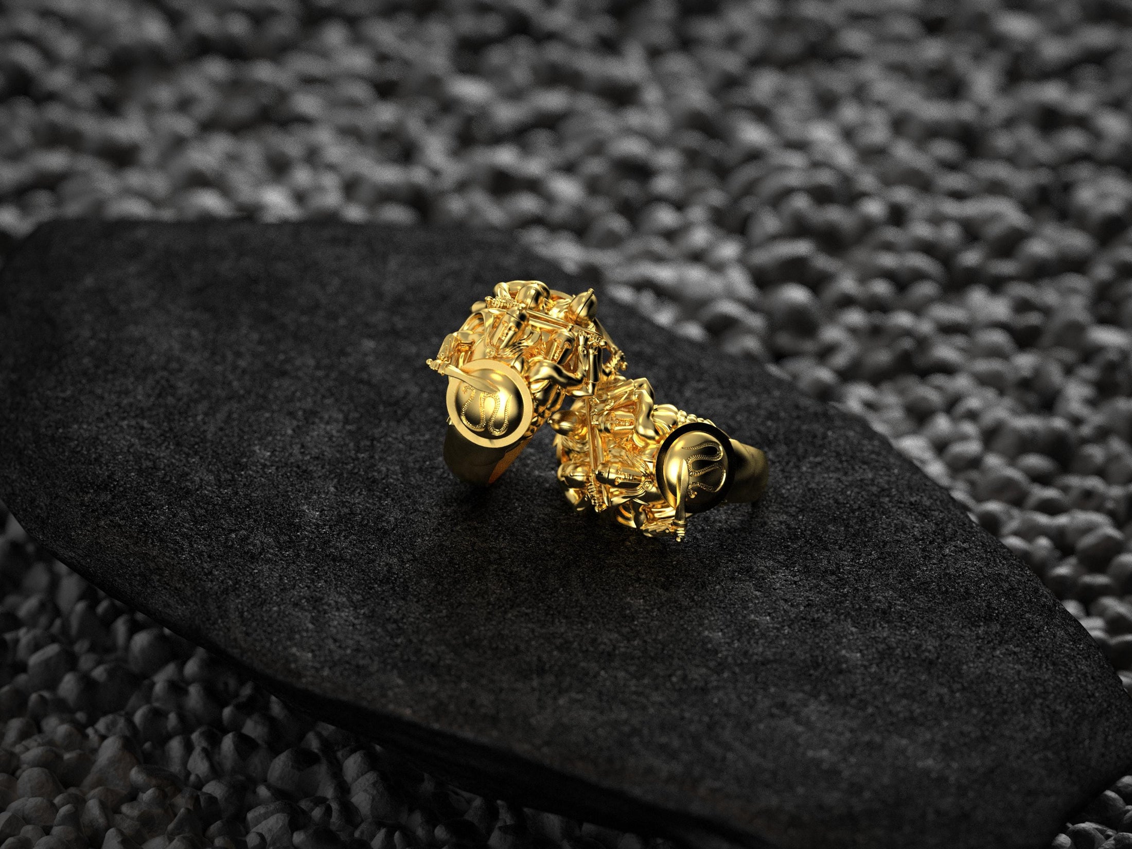 “Gold-plated pair of Spartan Phalanx signet rings photographed from rear, showing shield emblems and hoplite details against a dark backdrop.”