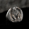 Bild in Galerie-Betrachter laden, Close-up of sterling silver griffin signet ring on black stone.