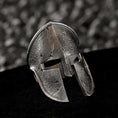 Load image into Gallery viewer, Three-quarter angle of the silver ring highlighting the depth of the helmet’s eye-slits and curved crest.