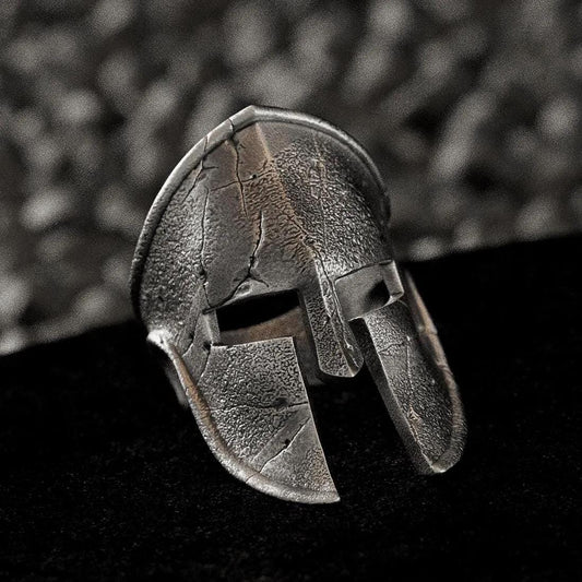 Three-quarter angle of the silver ring highlighting the depth of the helmet’s eye-slits and curved crest.