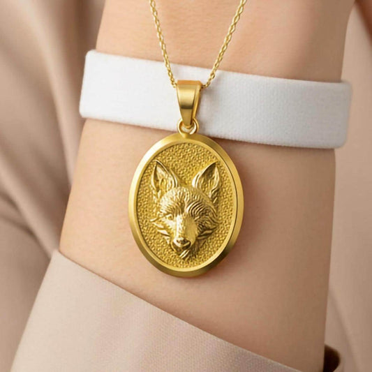 Fox head gold pendant close-up showing detailed fur texture.