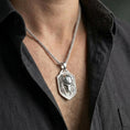 Load image into Gallery viewer, Polished silver protective eye ring worn on the finger, lifestyle photo showing sleek shine, crisp relief depth, and a modern talisman look.