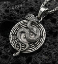 Load image into Gallery viewer, Oxidized yin yang dragon medallion pendant necklace on volcanic rock with detailed mythical dragon engraving