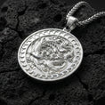 Load image into Gallery viewer, Polished silver dragon phoenix harmony pendant photographed on volcanic stone background