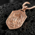 Load image into Gallery viewer, Rose gold plated fantasy dragon shield necklace presented on volcanic rock surface with dark mythic aesthetic