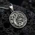 Load image into Gallery viewer, Oxidized silver dragon medallion pendant necklace with coiled dragon design on volcanic rock background