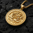 Load image into Gallery viewer, Gold plated dragon and phoenix medallion necklace symbolizing balance on volcanic rock