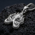 Load image into Gallery viewer, Polished silver octopus Cthulhu pendant necklace displayed on volcanic stone background with cosmic relief texture