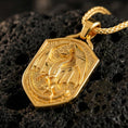 Load image into Gallery viewer, Gold plated medieval dragon shield pendant showcased on volcanic rock as a symbol of strength and protection