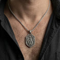 Load image into Gallery viewer, Oxidized coiled dragon shield pendant necklace worn on male model as a guardian talisman