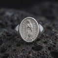 Load image into Gallery viewer, Polished silver Guadalupe Marian signet ring showcasing detailed religious relief on volcanic stone
