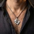 Load image into Gallery viewer, Polished silver Viking wolf Fenrir amulet worn on chest highlighting Nordic mythology symbolism