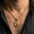 Load image into Gallery viewer, Gold plated winged lion pendant necklace worn by man as bold mythic statement jewelry