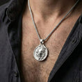 Load image into Gallery viewer, Polished silver Medusa amulet necklace worn on chest highlighting ancient Greek symbolism and strength