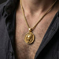 Load image into Gallery viewer, Gold plated Medusa pendant necklace worn by man as bold mythology statement jewelry
