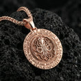 Load image into Gallery viewer, Rose gold plated Lovecraftian Cthulhu pendant necklace presented on volcanic rock surface with dark occult aesthetic