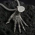 Load image into Gallery viewer, Oxidized Hand of Maliketh pendant necklace photographed on volcanic rock with detailed clawed hand relief and gothic texture