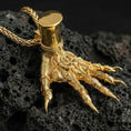 Load image into Gallery viewer, Gold plated Hand of Maliketh gamer pendant showcased on volcanic rock as a symbol of dark power and legendary warrior style