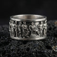 Load image into Gallery viewer, Oxidized ancient Greek philosopher band ring photographed on volcanic rock with high-relief classical figures and historical frieze detail
