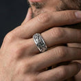 Load image into Gallery viewer, Polished silver phoenix engraved spinner band worn on hand emphasizing smooth motion and symbolic firebird detailing