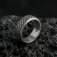 Load image into Gallery viewer, Oxidized Japanese cloud motif band ring photographed on volcanic rock, featuring traditional swirling “kumo” wind-and-cloud relief with artisan-carved texture