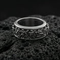 Load image into Gallery viewer, Oxidized sterling silver spinner fidget Greek crowd ring photographed on volcanic rock with high-relief ancient procession engraving