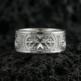 Load image into Gallery viewer, White Gold Knights Hospitaller Maltese cross wedding band showcased on volcanic rock with heritage-inspired fleur de lis pattern and bold masculine profile
