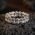 Load image into Gallery viewer, Polished silver industrial chain ring displayed on volcanic stone background, highlighting high-contrast metal edges and precision link structure